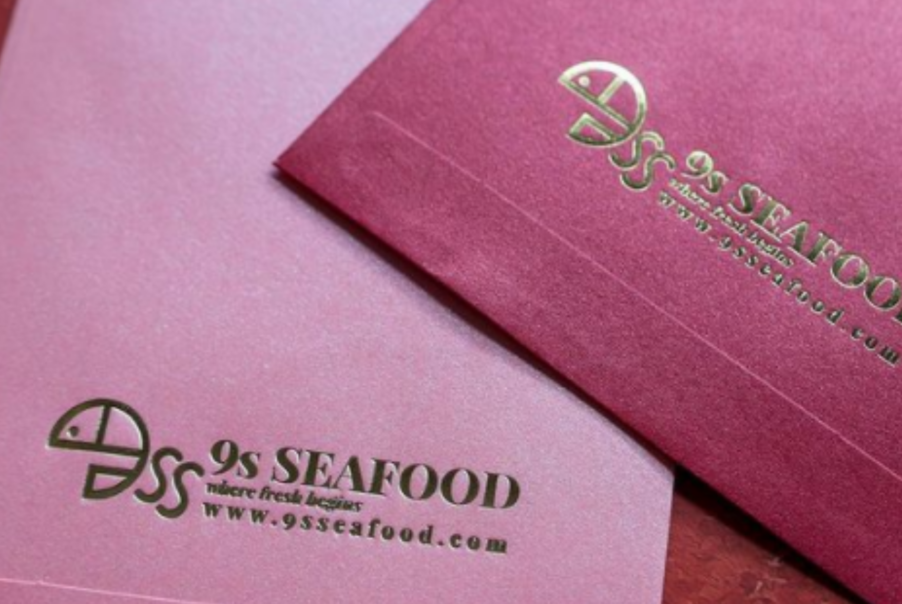 Red packets with the 9s Seafood logo debossed on them